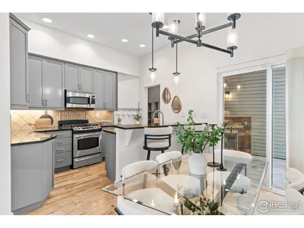 a kitchen with kitchen island granite countertop a sink cabinets and window