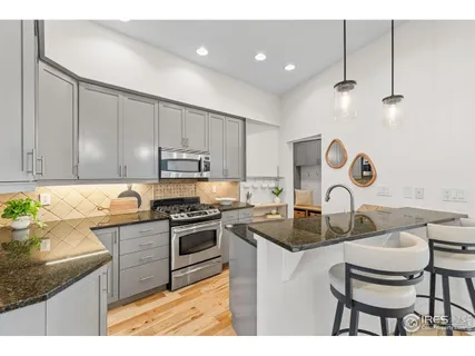 a kitchen with stainless steel appliances a refrigerator and a stove top oven