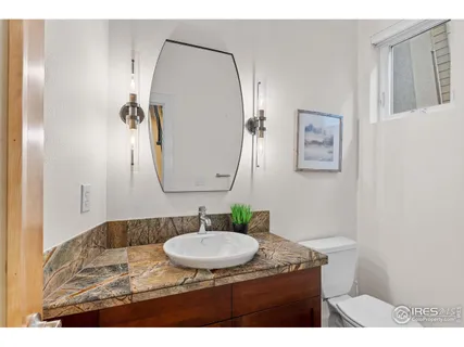 a bedroom with a bed a fireplace and a chandelier