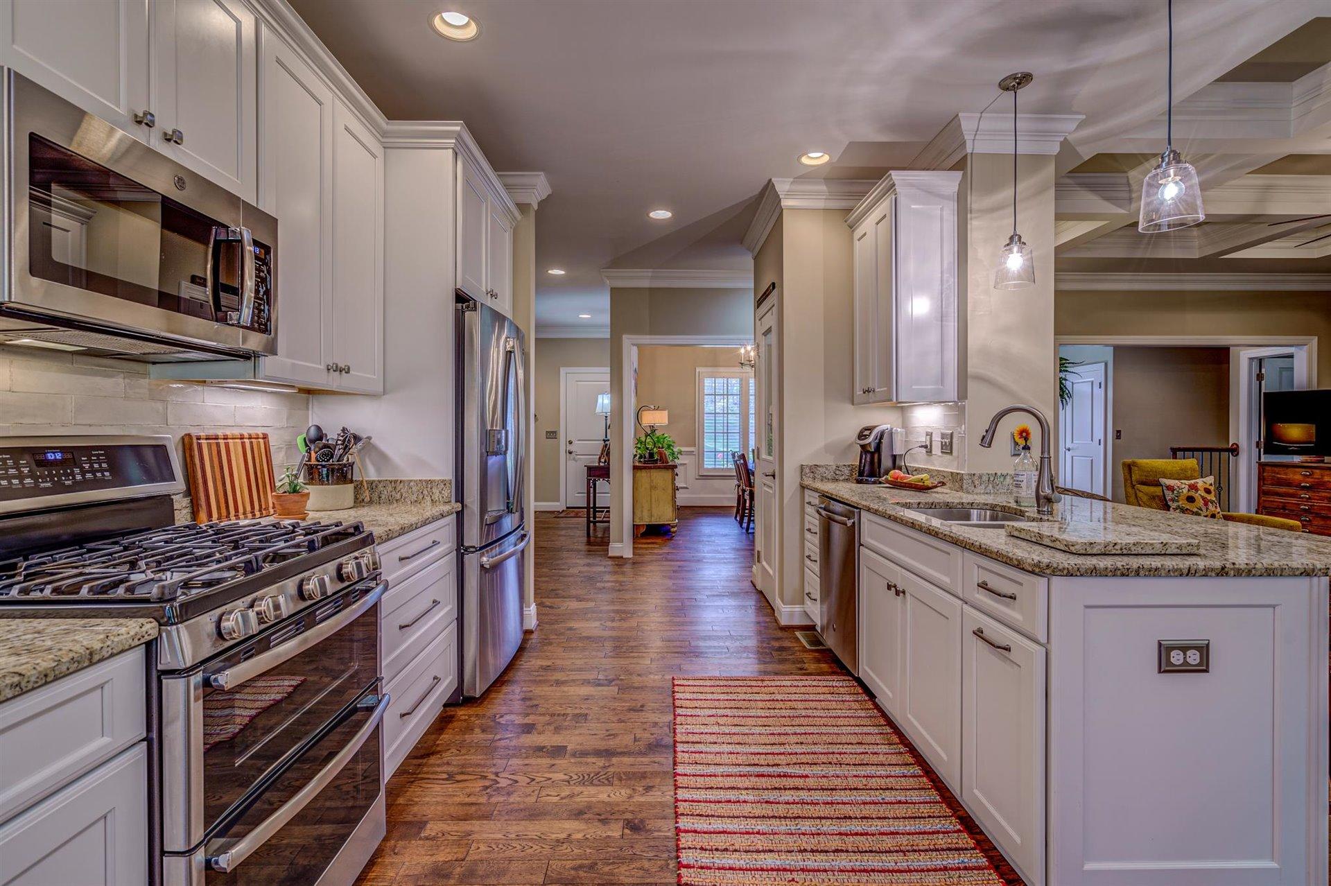 6989 Fairway Ridge Road Salem, VA 24153 - Photo 16 of 51 a kitchen with stainless steel appliances granite countertop a stove top oven a sink dishwasher a refrigerator and a cabinets