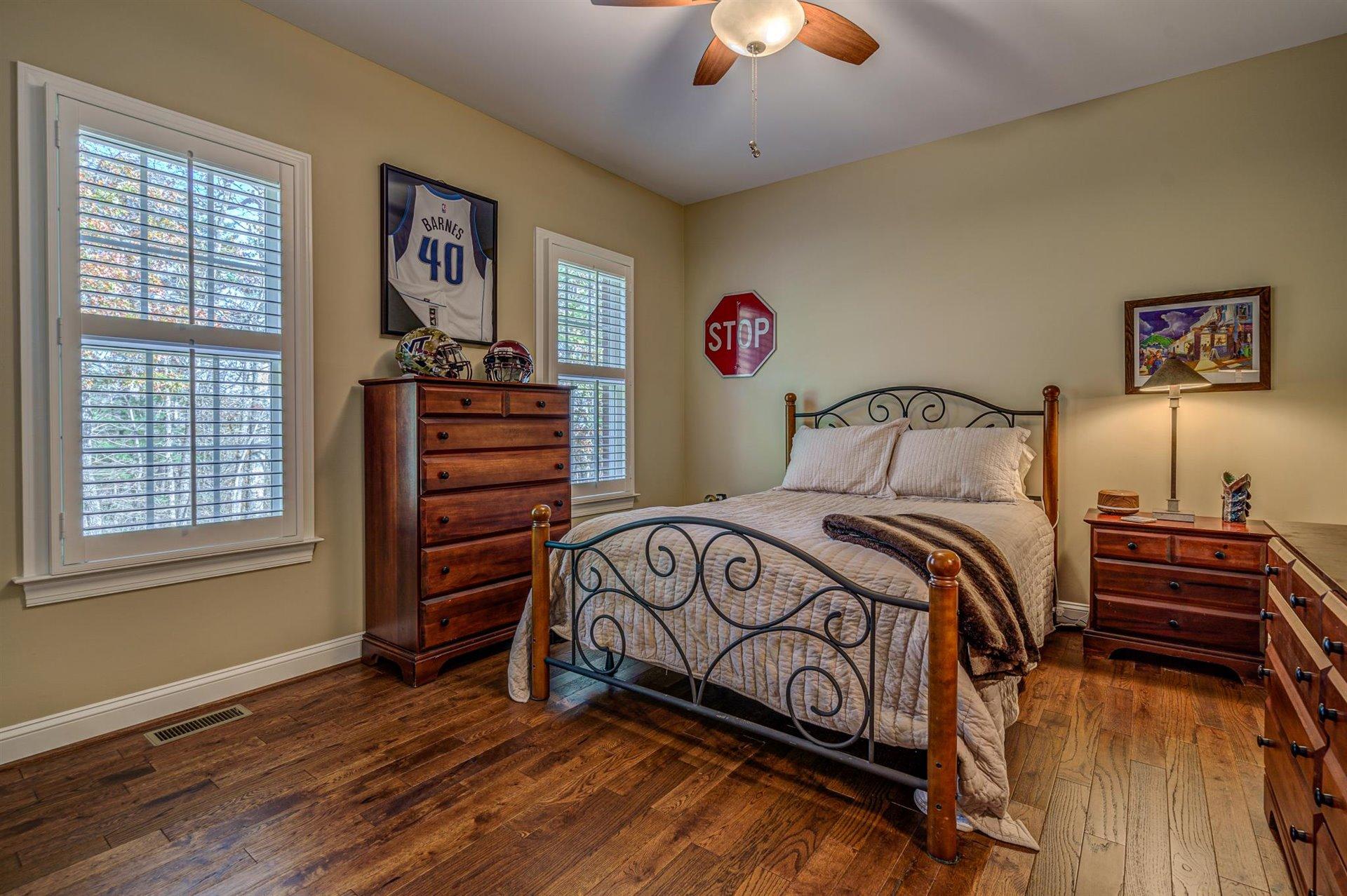 6989 Fairway Ridge Road Salem, VA 24153 - Photo 35 of 51 a bedroom with a bed and a chandelier