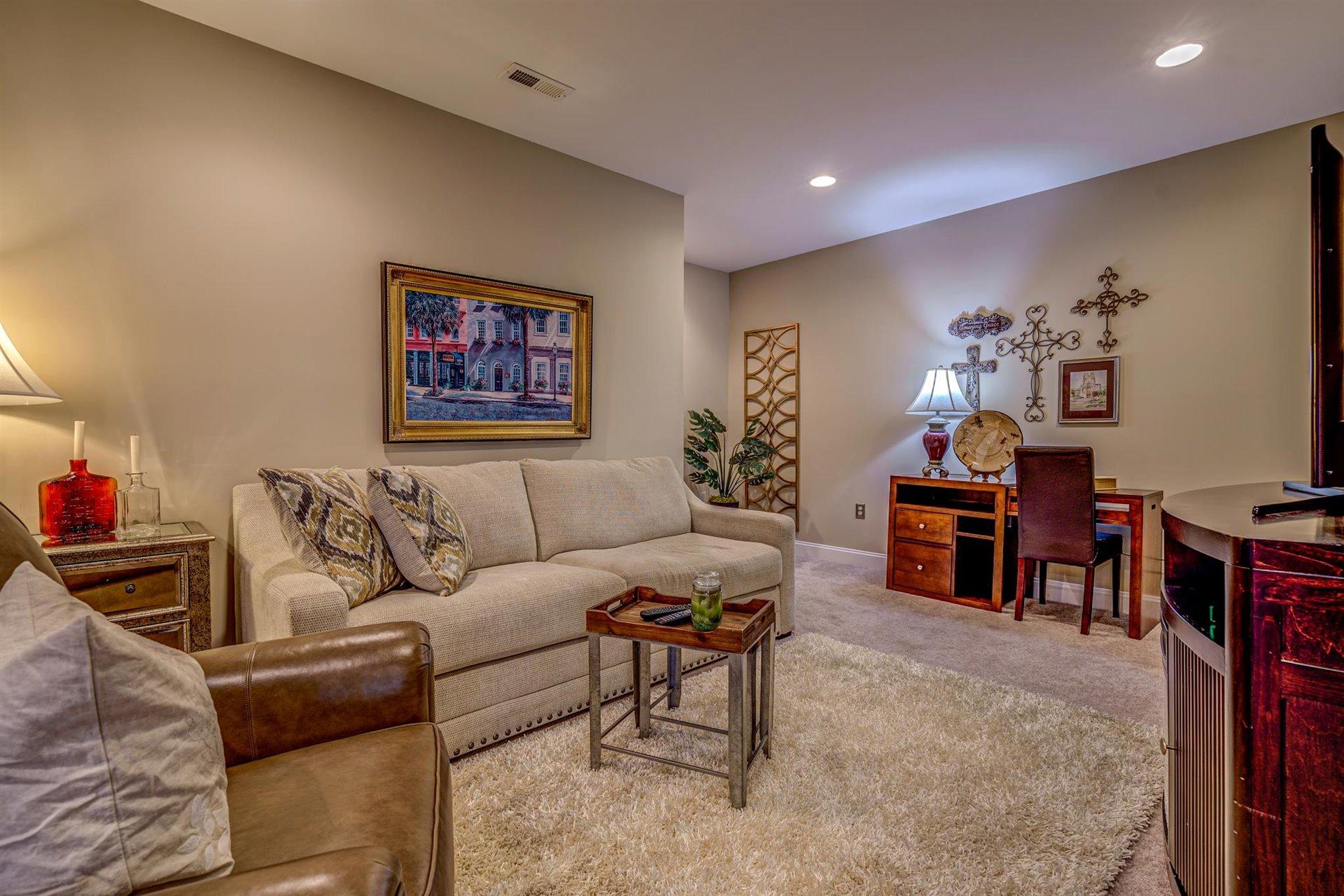 6989 Fairway Ridge Road Salem, VA 24153 - Photo 37 of 51 a living room with furniture and a dining table with bookshelf next to a window