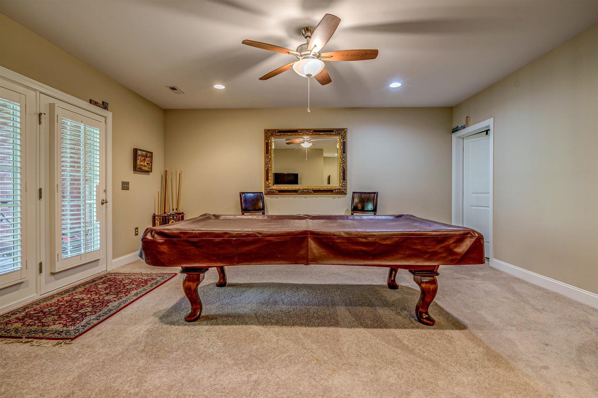 6989 Fairway Ridge Road Salem, VA 24153 - Photo 38 of 51 a bedroom with a bed and a chandelier