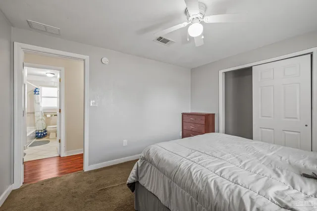 a bathroom with a toilet sink and a mirror