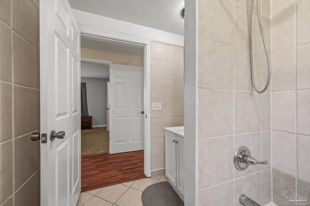 a bed sitting in a bedroom next to a bathroom