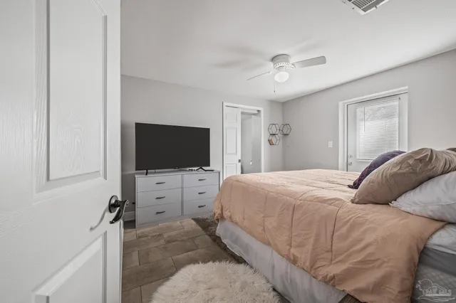 a bedroom with a bed and a window