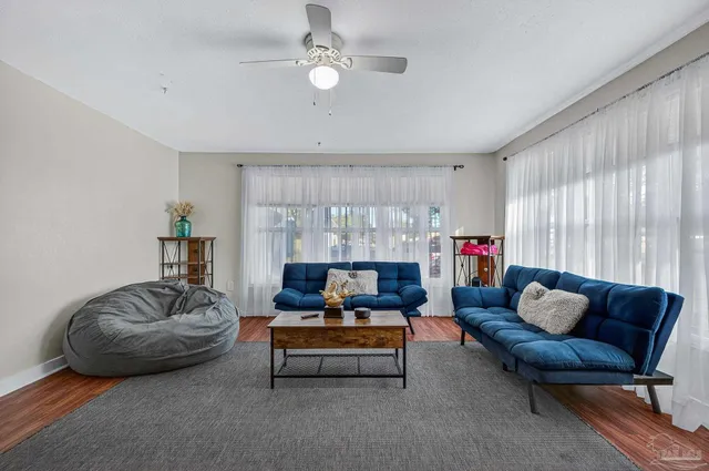 a living room with furniture and a chandelier