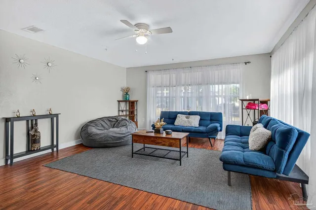 a living room with furniture and wooden floor