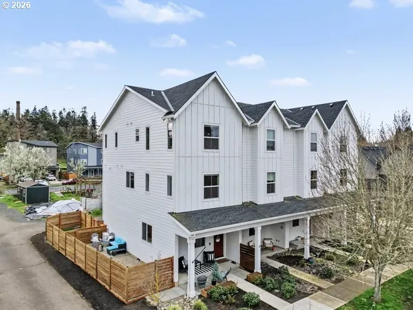 a aerial view of a house with a yard and potted plants