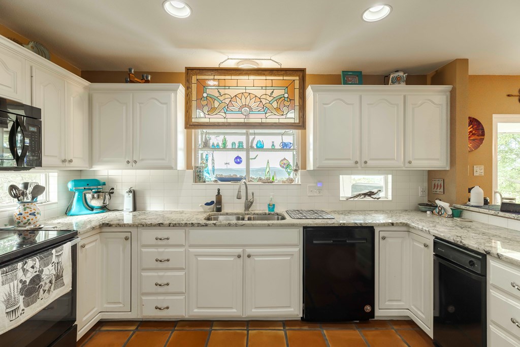 116 Ridge Road West Ingram, TX 78025 - Photo 14 of 65 a kitchen with stainless steel appliances granite countertop a sink window and cabinets