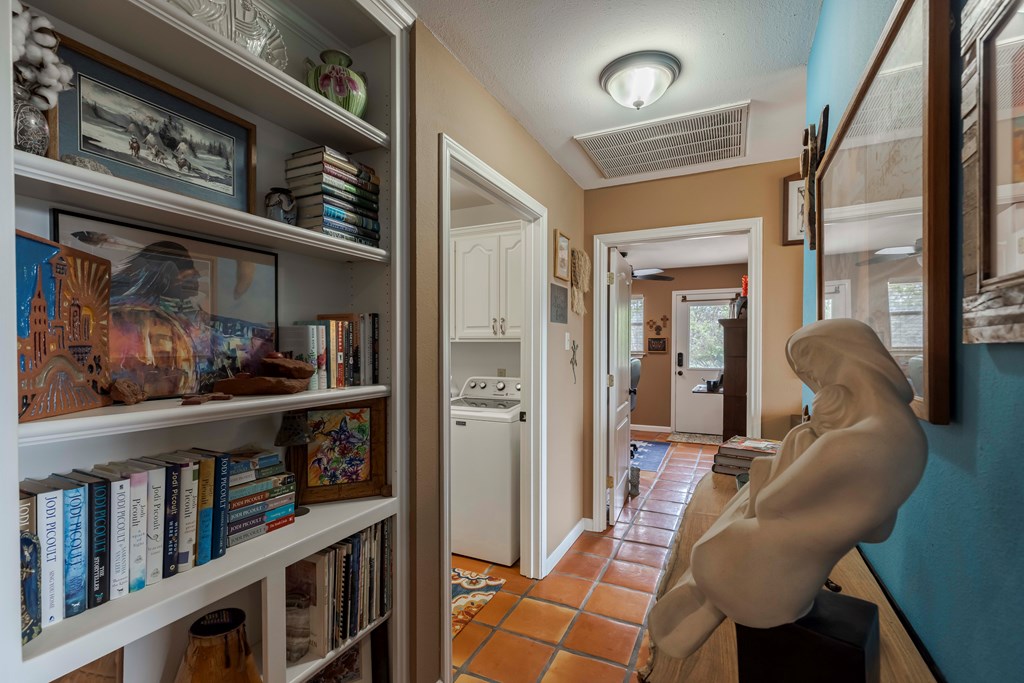 116 Ridge Road West Ingram, TX 78025 - Photo 19 of 65 a living room with lots of furniture and a book shelf