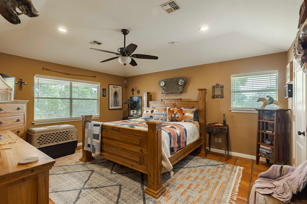 116 Ridge Road West Ingram, TX 78025 - Photo 21 of 65 a bed room with a bed and a large window