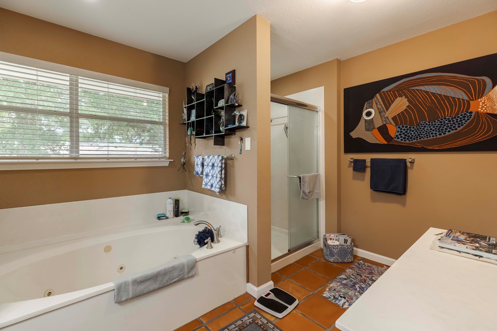 116 Ridge Road West Ingram, TX 78025 - Photo 25 of 65 a bathroom with a bathtub and a window