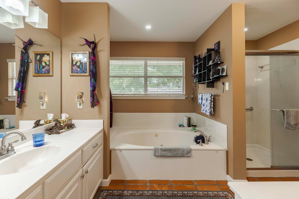 116 Ridge Road West Ingram, TX 78025 - Photo 26 of 65 a bathroom with a tub sink a mirror and a shower