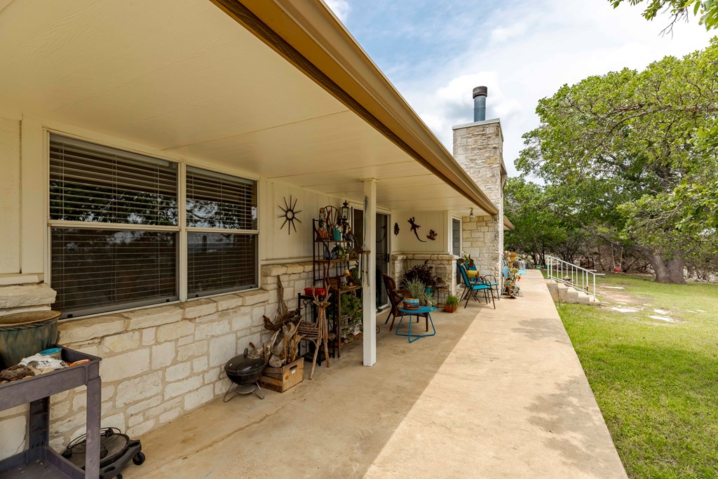 116 Ridge Road West Ingram, TX 78025 - Photo 37 of 65 a view of a patio with table and chairs with wooden floor and fence