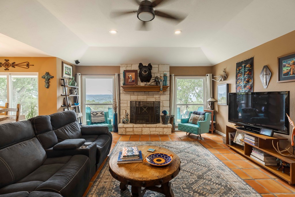 116 Ridge Road West Ingram, TX 78025 - Photo 10 of 65 a living room with furniture a flat screen tv and a fireplace