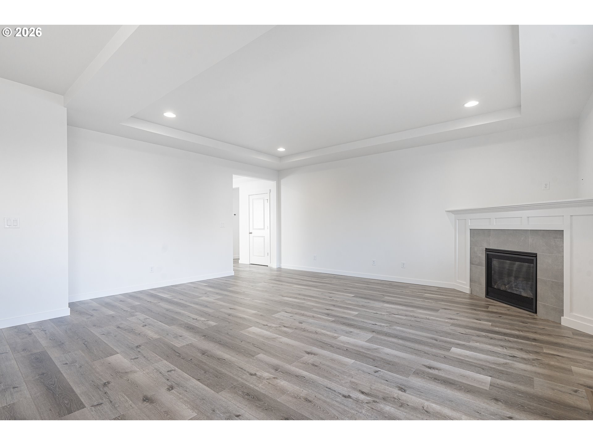 673 Parker Loop Silverton, OR 97381 - Photo 11 of 37 a view of an empty room with wooden floor fireplace and a window