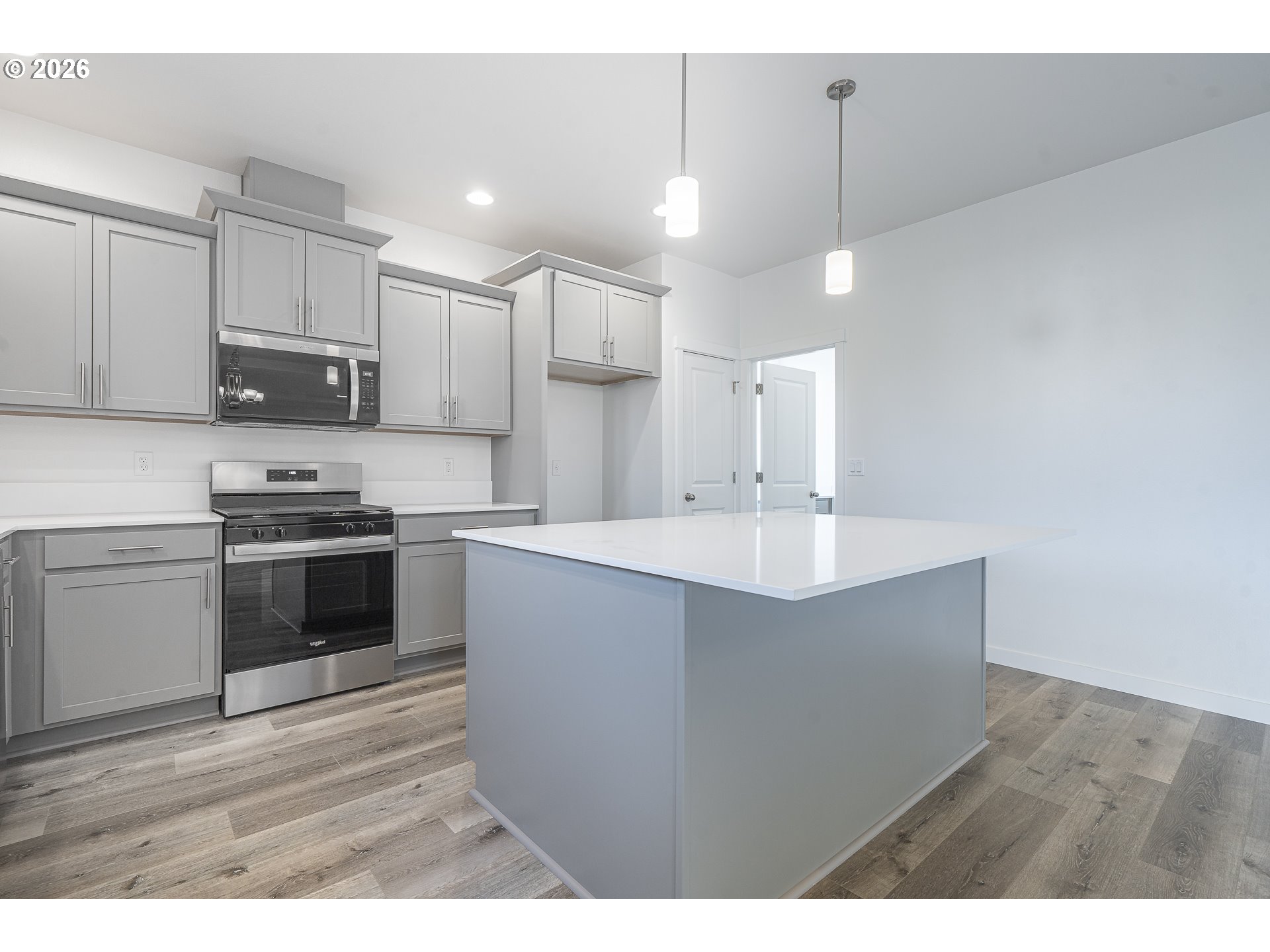 673 Parker Loop Silverton, OR 97381 - Photo 17 of 37 a kitchen with kitchen island a sink stainless steel appliances and cabinets