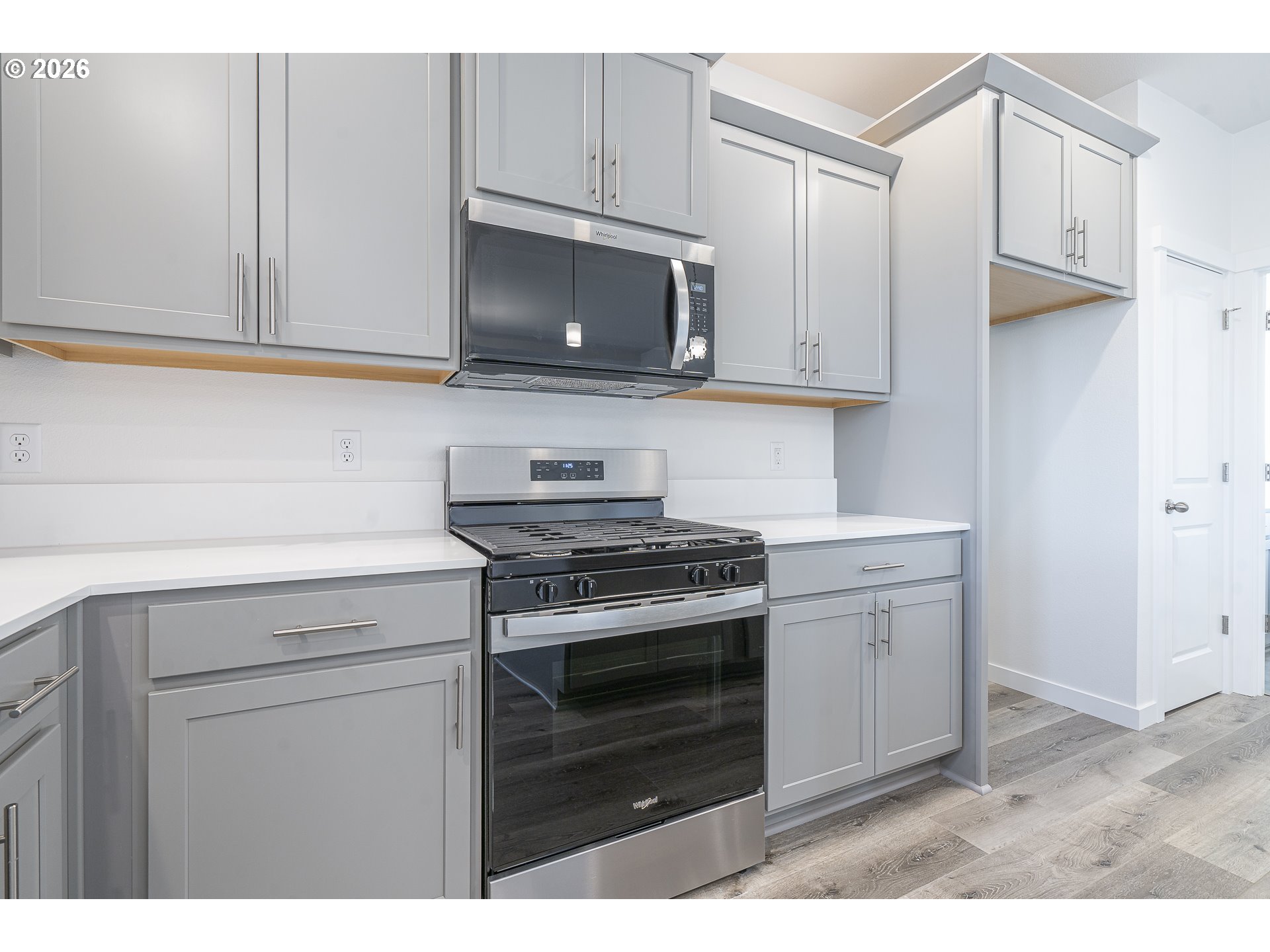 673 Parker Loop Silverton, OR 97381 - Photo 18 of 37 a kitchen with stainless steel appliances a stove a microwave and cabinets