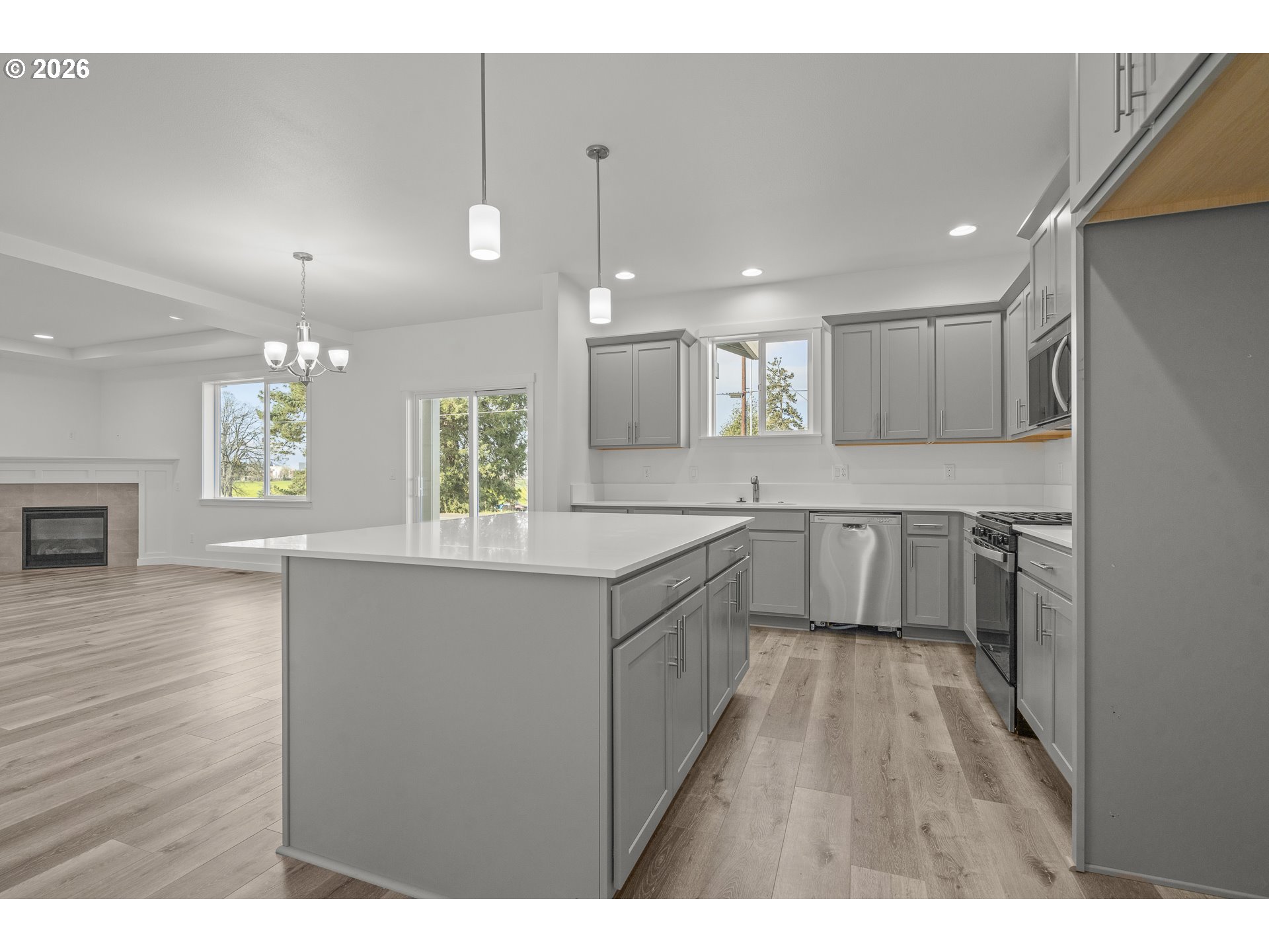 673 Parker Loop Silverton, OR 97381 - Photo 21 of 37 a large kitchen with granite countertop a sink cabinets and wooden floor