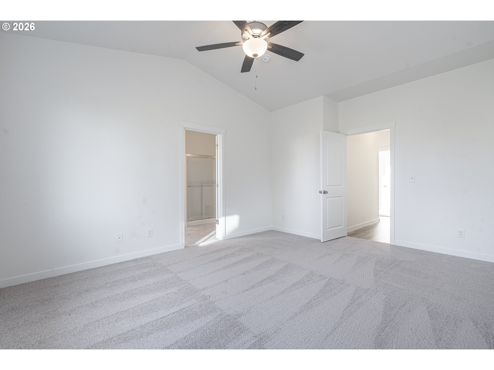 673 Parker Loop Silverton, OR 97381 - Photo 32 of 37 a view of an empty room with chandelier fan and wooden floor