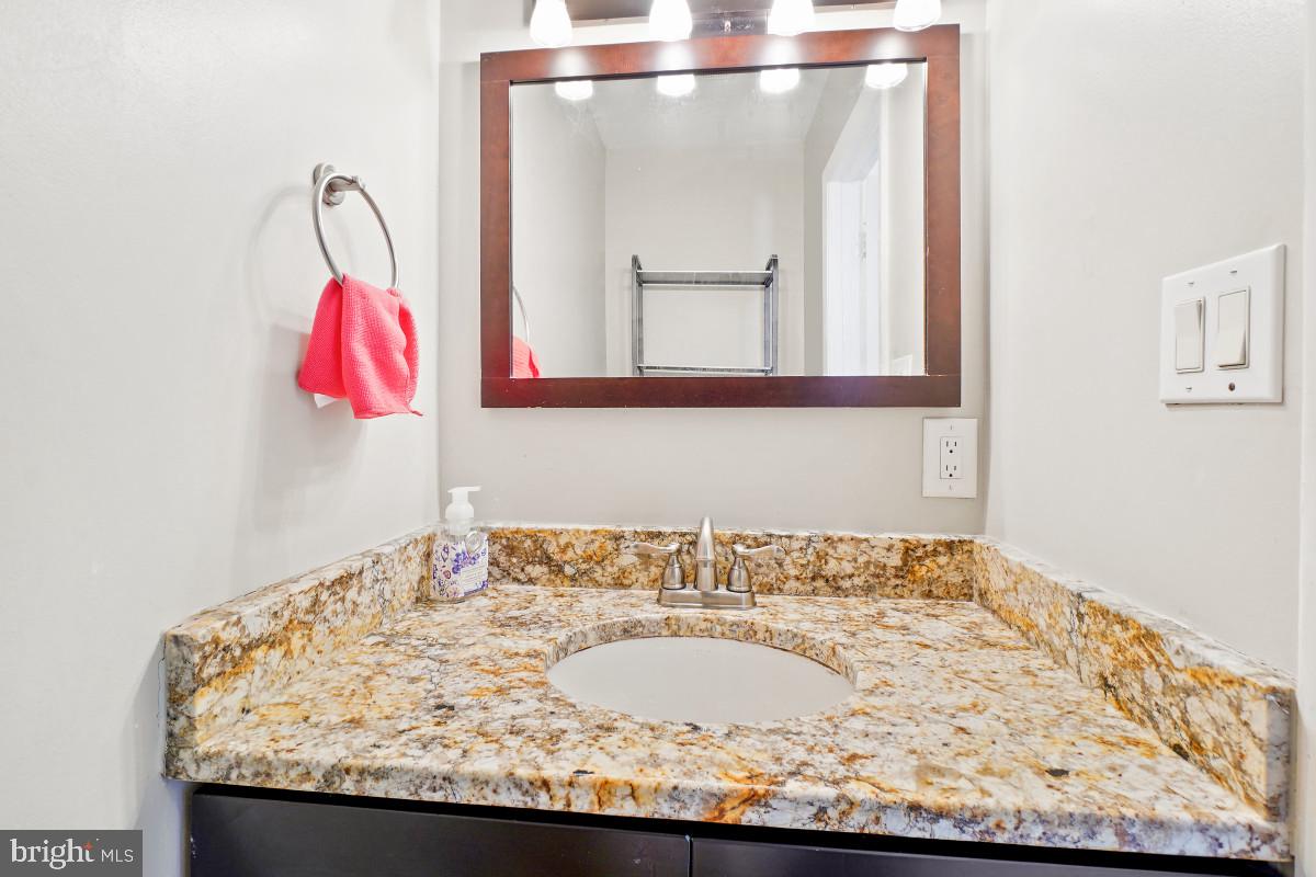 35 Bellfalls Way Nottingham, MD 21236 - Photo 4 of 30 a bathroom with a granite countertop sink and a mirror