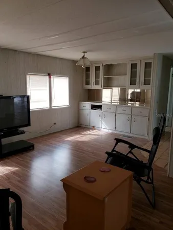 a view of a livingroom with furniture and a flat screen tv