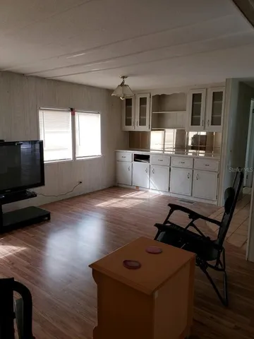 a view of a livingroom with furniture and a flat screen tv