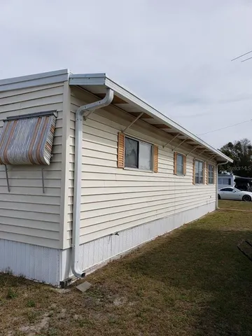 a view of a house with a backyard