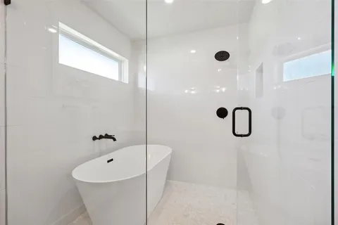 a bathroom with a bathtub and shower