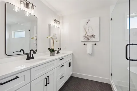 a bathroom with 2 sink and mirror