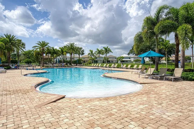 a bathroom with a granite countertop sink a mirror and a shower