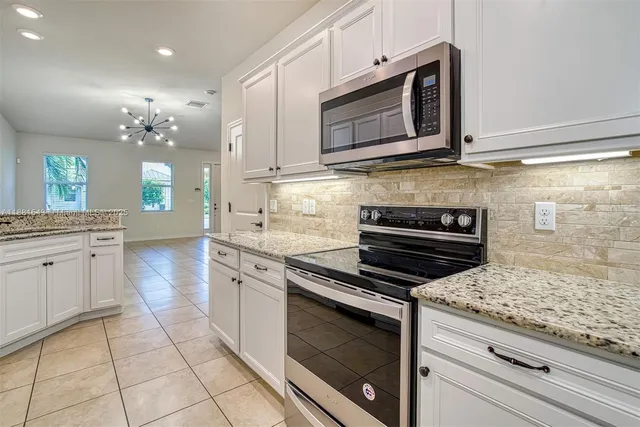 a kitchen with cabinets appliances and a counter space