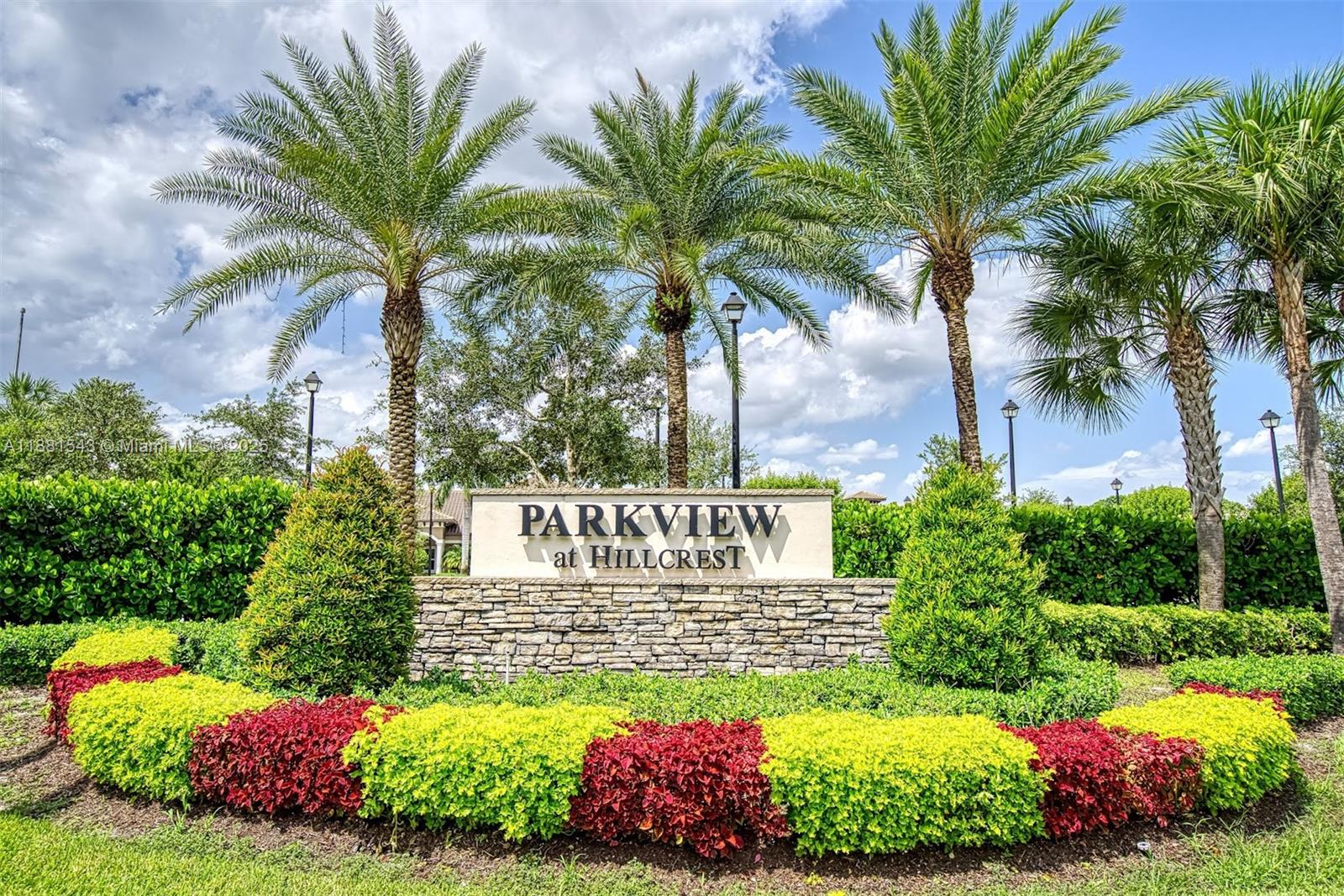 5060 Eucalyptus Drive, Unit 2 Hollywood, FL 33021 - Photo 22 of 43 a sign that is sitting in front of flowers