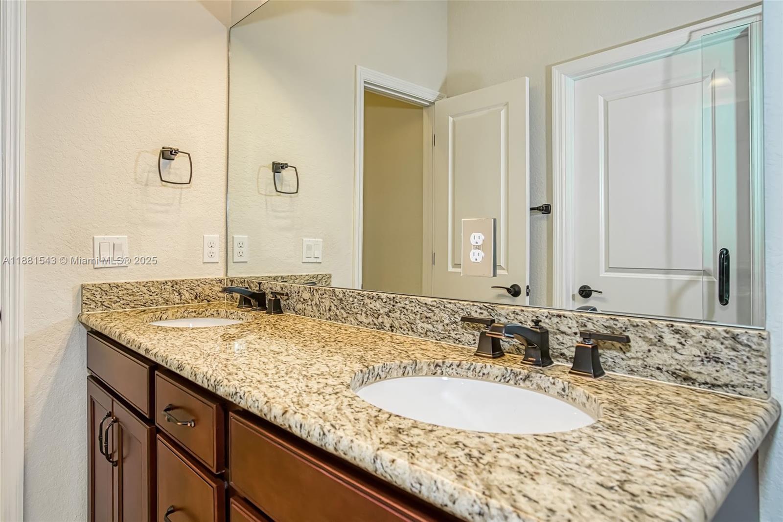 5060 Eucalyptus Drive, Unit 2 Hollywood, FL 33021 - Photo 24 of 43 a bathroom with a granite countertop sink and a mirror