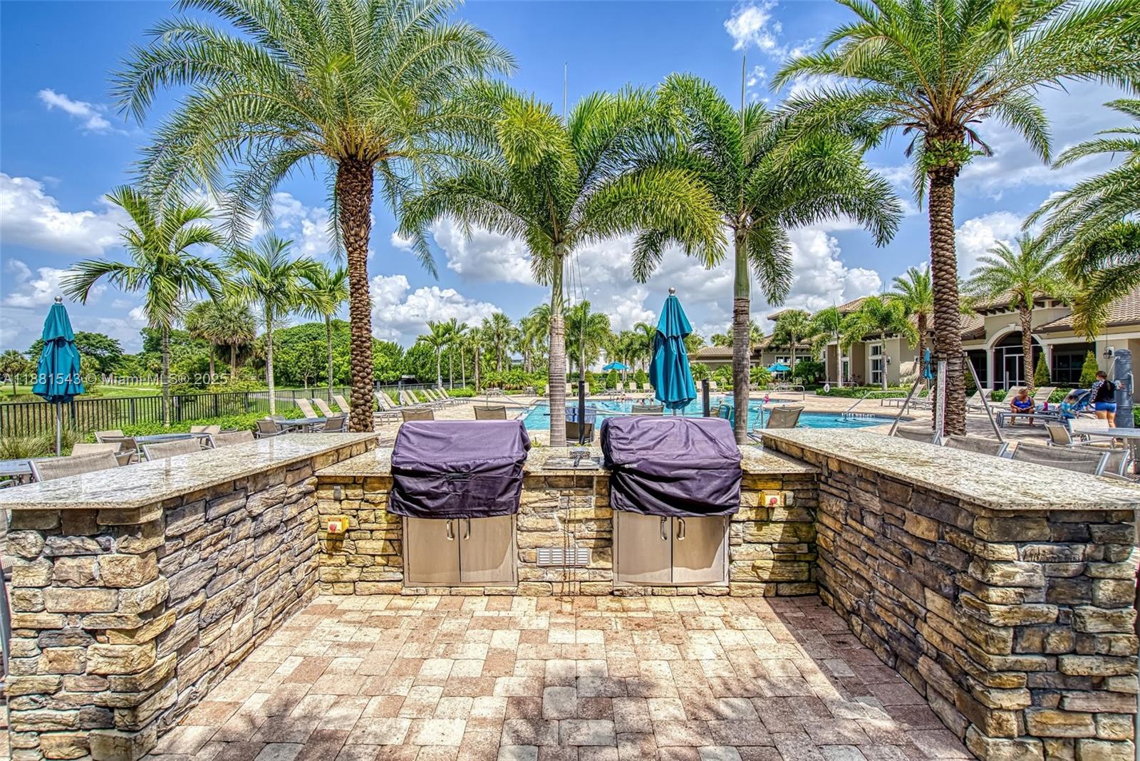5060 Eucalyptus Drive, Unit 2 Hollywood, FL 33021 - Photo 33 of 43 a view of swimming pool with a table and chairs