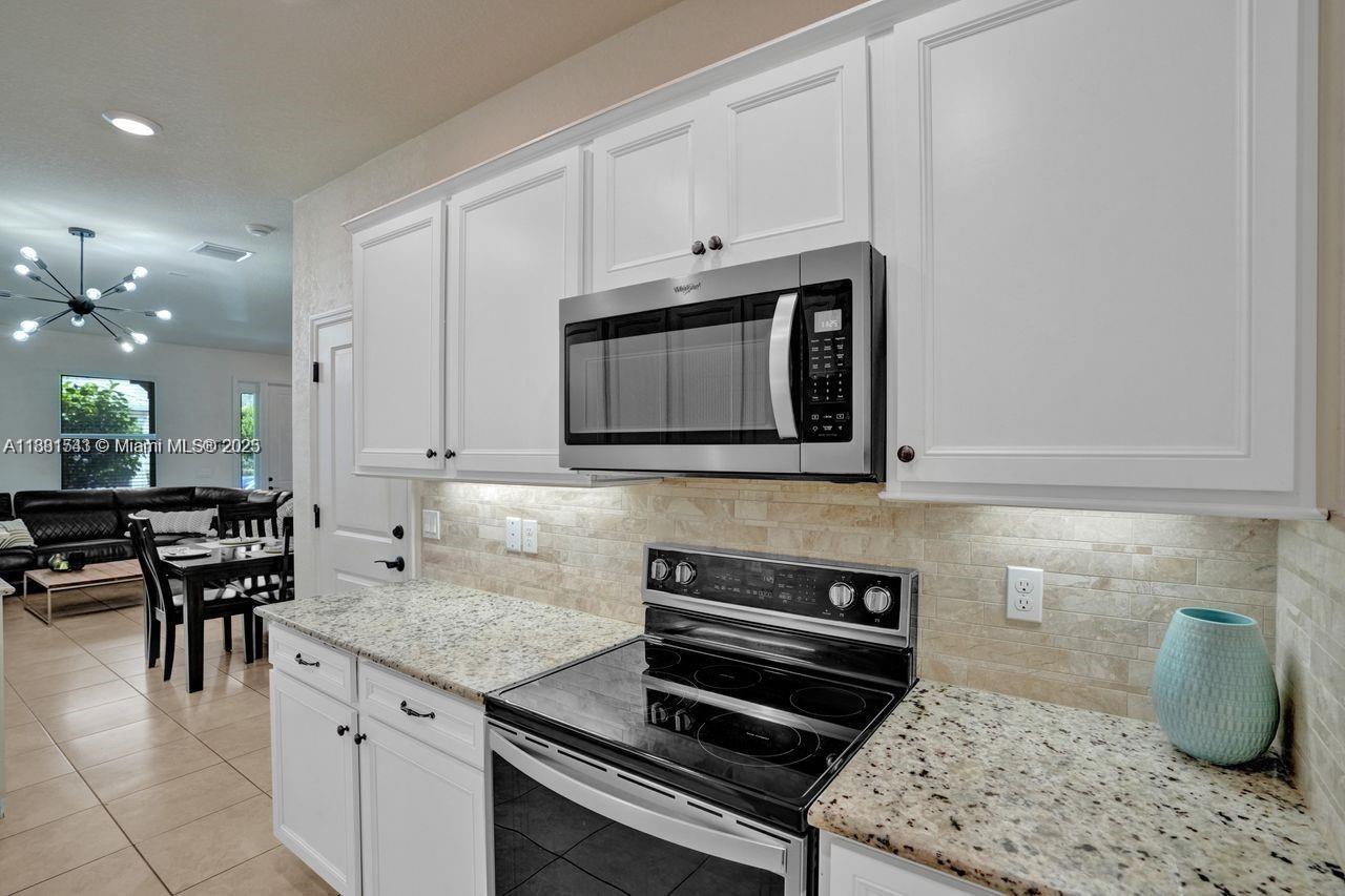 5060 Eucalyptus Drive, Unit 2 Hollywood, FL 33021 - Photo 35 of 43 a kitchen with a stove and a microwave