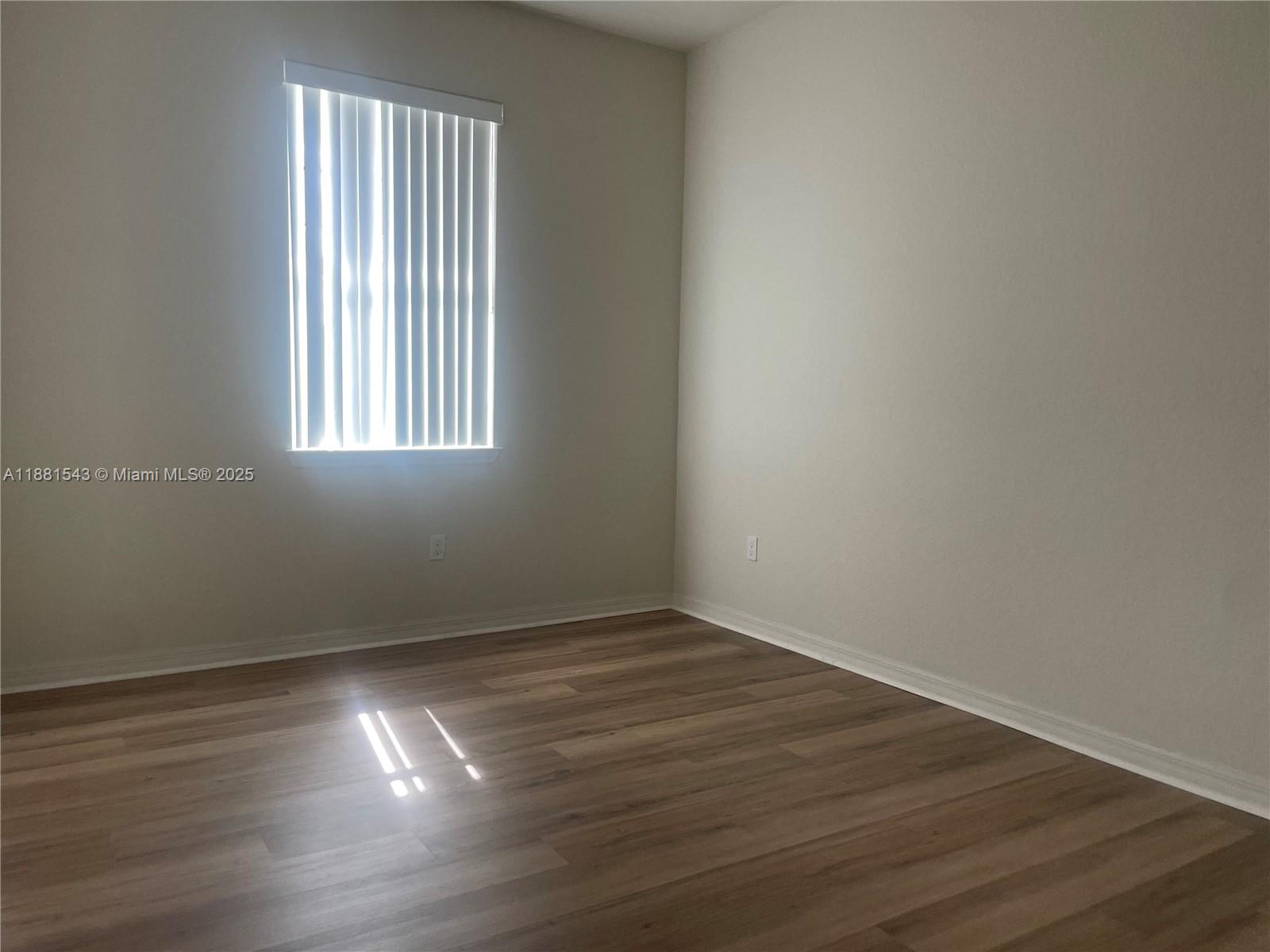 5060 Eucalyptus Drive, Unit 2 Hollywood, FL 33021 - Photo 36 of 43 a view of an empty room with wooden floor and a window