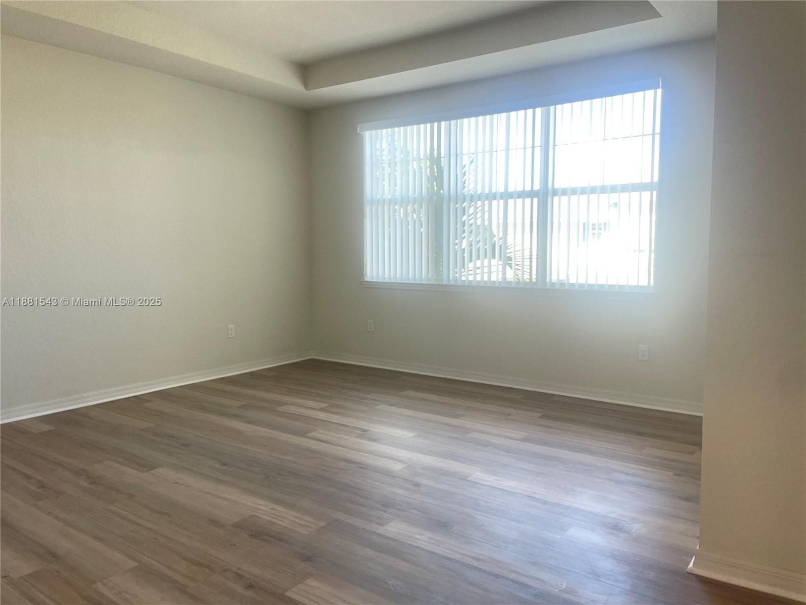 5060 Eucalyptus Drive, Unit 2 Hollywood, FL 33021 - Photo 42 of 43 an empty room with wooden floor and windows