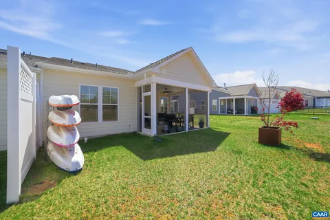 a view of a house with backyard and porch