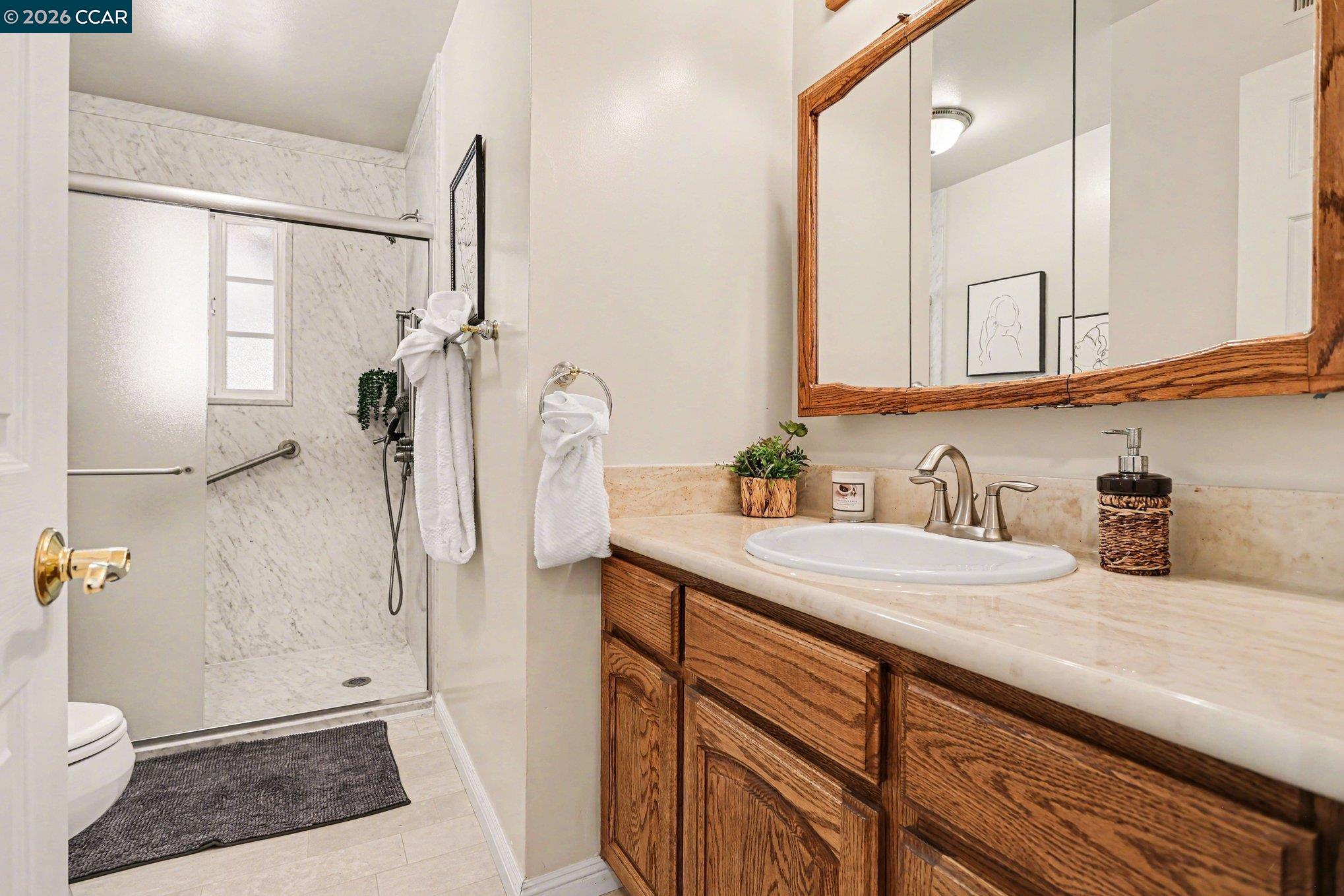 1451 Franklin Canyon Road Martinez, CA 94553 - Photo 16 of 45 a bathroom with a sink a toilet and shower