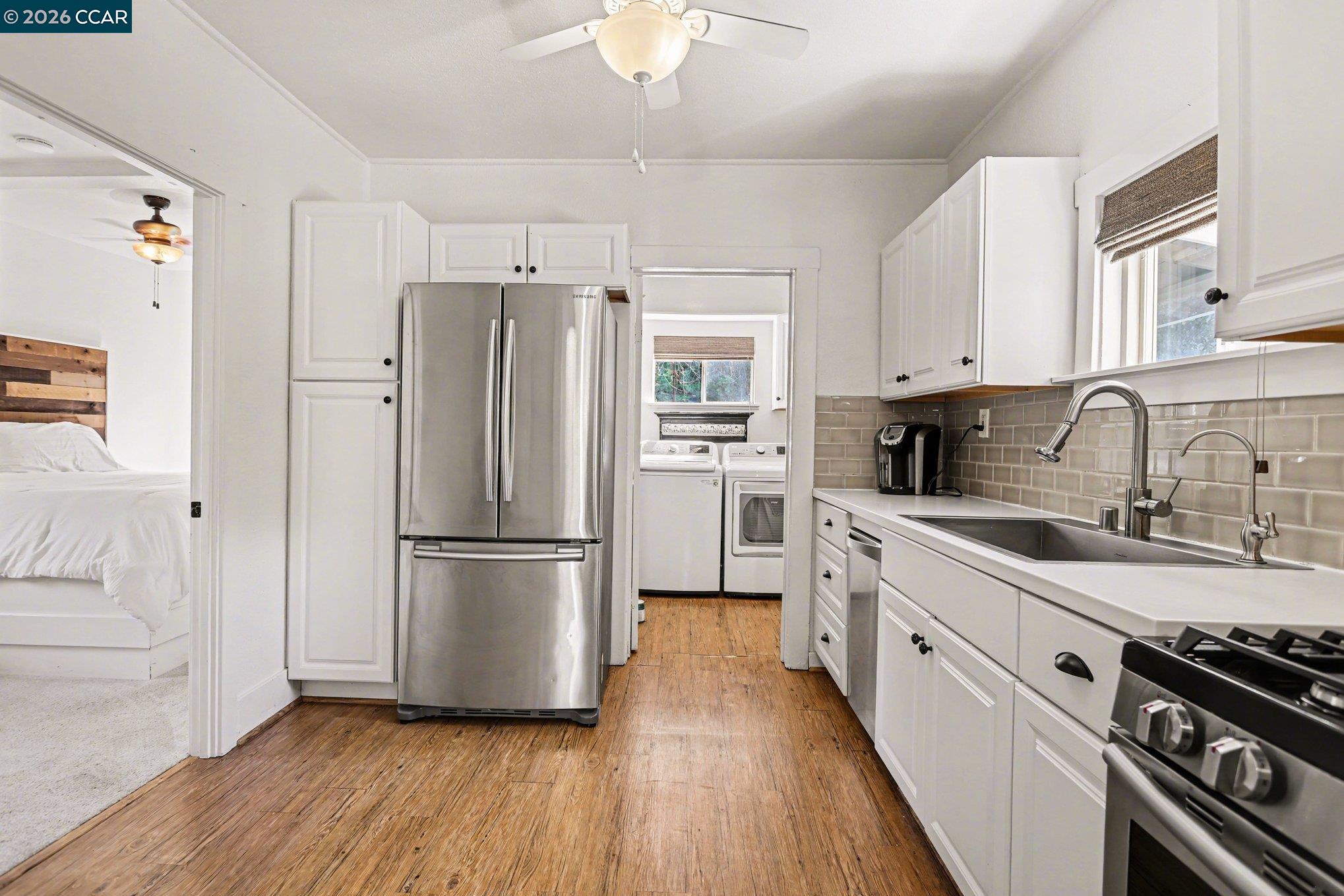 1451 Franklin Canyon Road Martinez, CA 94553 - Photo 32 of 45 a kitchen with stainless steel appliances a refrigerator sink and wooden floor