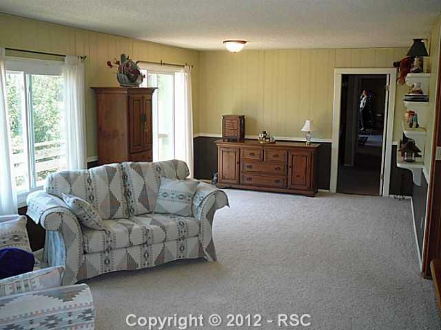 12070 Northcliff Road Elbert, CO 80106 - Photo 12 of 24 Master suite sitting area w/ private deck & cozy woodstove