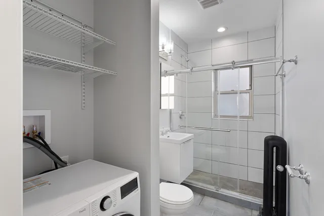 a bathroom with a toilet and a shower