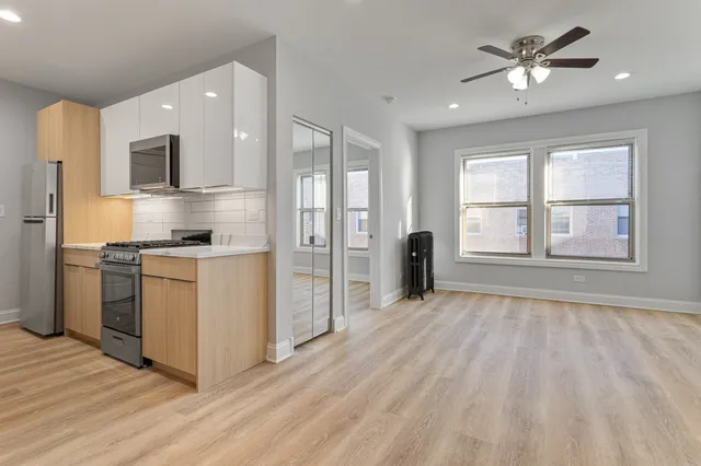 a view of a kitchen with a stove cabinets and wooden floor