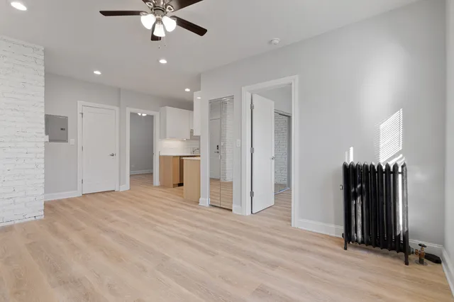 a view of a livingroom with a hardwood floor and a ceiling fan