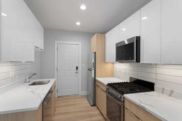 a kitchen with a sink stove and refrigerator