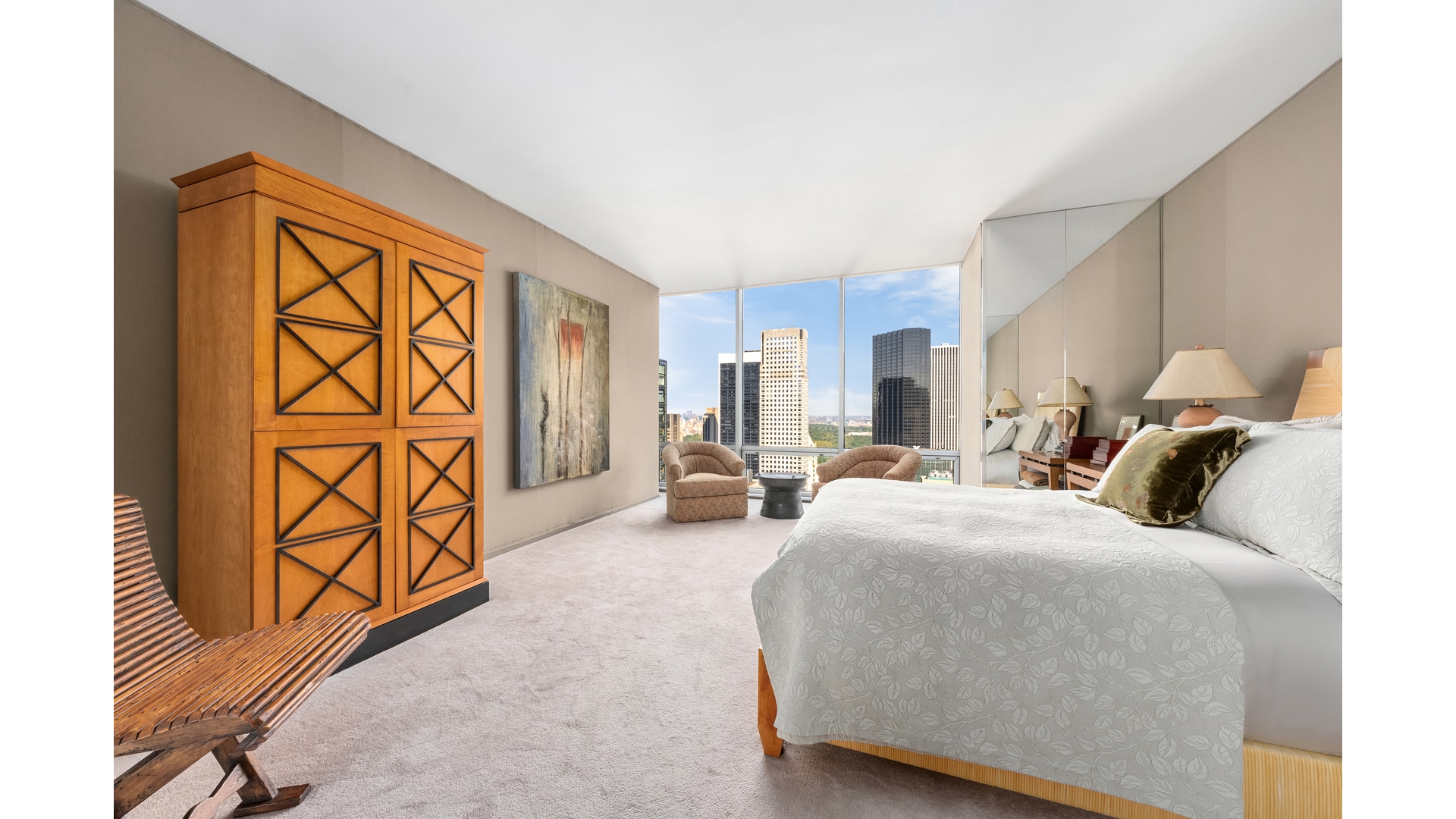 641 5th Avenue, Unit 35A Manhattan, NY 10022 - Photo 3 of 10 a bedroom with a bed and a walk in closet with wooden floor