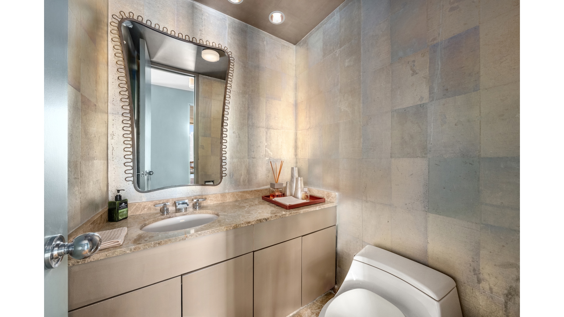 641 5th Avenue, Unit 35A Manhattan, NY 10022 - Photo 6 of 10 a bathroom with a granite countertop sink a mirror and a toilet