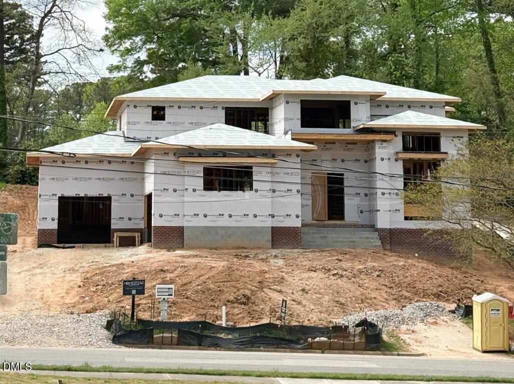 a view of a white house with large windows